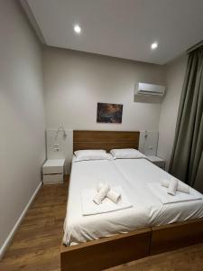 a bedroom with a bed with two towels on it at Urban Room 2 in Tirana