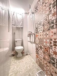 a bathroom with a toilet and a shower at La Casa Di Decembre 17/35 Nguyễn Như Đổ in Hanoi