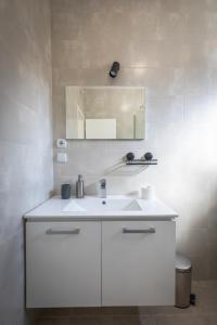 La salle de bains est pourvue d'un lavabo blanc et d'un miroir. dans l'établissement Villa Luca Christo, à Mrzenci
