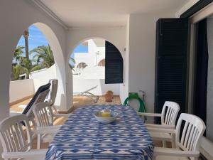a table with white chairs and a blue and white table cloth at ALBATROS 48 by SOM Menorca in Son Parc