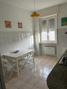 uma cozinha com mesa e cadeiras num quarto em Casa di Bianca em Lerici