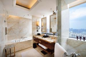 a bathroom with a tub and a sink and a mirror at The Ritz-Carlton, Chengdu in Chengdu