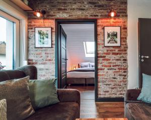 a room with a brick wall and a bedroom at apartament BB in Podgórzyn