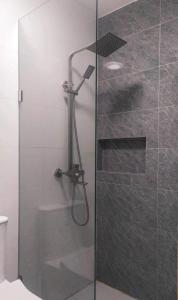 a shower in a bathroom with a glass door at Saphir Townhouse 5 to 6 pax rooftop terrace, Cavite in Imus +4 photos