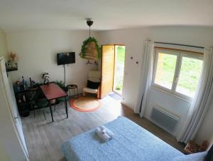 a living room with a teddy bear on the floor at EVASION NATURE ET CONVIVIALITÉ in Sourcieux-les-Mines