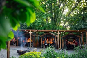 a group of people sitting at tables in a garden at Llys Meddyg in Newport Pembrokeshire