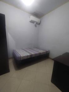 a room with a bed in the corner of a room at SPOT ON 93853 Budi Residence 2 in Bekasi