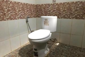 a bathroom with a white toilet in a room at Capital O 93882 The Pondok Palma Villa & Resto in Yogyakarta