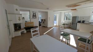 a kitchen and living room with a table and chairs at Wülde Hoamat in Eisenerz