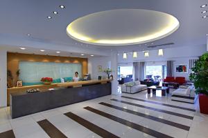 a lobby of a hotel with a woman in the lobby at Kythea Resort in Agia Pelagia