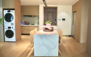 a kitchen with a table with a plant on it at Stylish 3 RMs city APT, with laundry sets, Easy to go main locations in Zhangjiajie