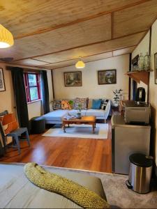 a living room with a couch and a table at Danseys Pass Lavender Farm in Tokarahi