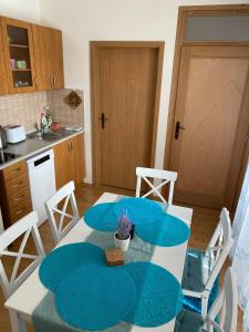a kitchen with a table and chairs and a kitchen with a table and a table at Apartmán Diana in Oščadnica