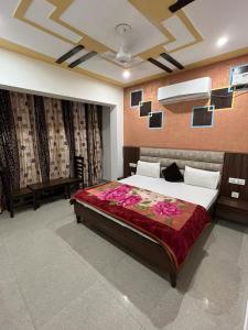 a bedroom with a large bed with flowers on it at Hotel Chandigarh inn in Chandīgarh