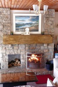 a fireplace with a painting on top of it at Killarney View House B&B in Killarney