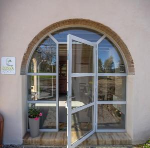 チェルタルドにあるRelais Borgo Elissaの建物内の開口窓付きのアーチ型窓