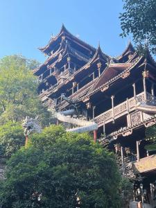 a large building with trees in front of it at Pikkie Designer's Stylish Three Bed Room Apartmemt in Zhangjiajie