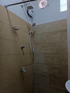 a shower with a shower head in a bathroom at Richland's Villa in Kandy
