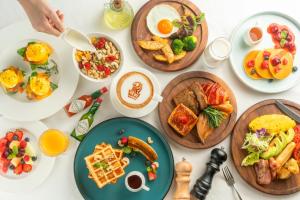 a table with plates of breakfast food on it at The Ritz-Carlton, Chengdu in Chengdu