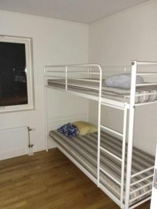 a couple of bunk beds in a room at Chill and stay in Ösmo