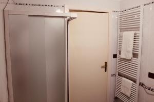y baño con ducha y puerta de cristal. en Maison Luigi - Casa Vacanze1, en Nociglia