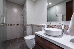 a bathroom with a sink and a shower and a toilet at Goldbest-Reva Burj Khalifa view in Dubai