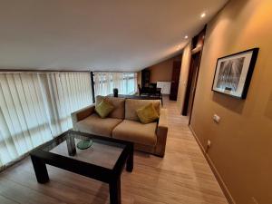 a living room with a couch and a coffee table at Apartamento Enol in Cangas de Onís