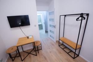 a room with a table and a mirror at Budget Apartment in Prague