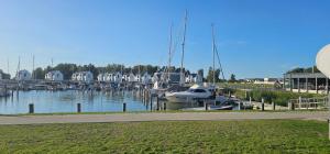 a marina with boats in the water and houses at Mobilheim Marine Glück im Yachthafen Peenemünde in Peenemünde