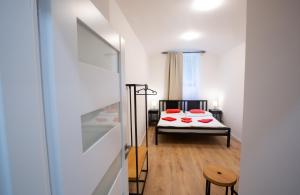 a bedroom with a bed with red pillows on it at Budget Apartment in Prague
