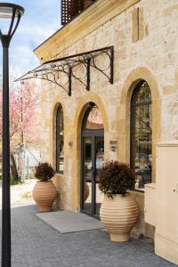 two large vases sitting outside of a building at Bizarre Boutique Hotel in Varna City