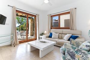 a living room with a couch and a table at 2 bedroom Villa Destu with private pool and golf views, Aphrodite Hills Resort in Kouklia