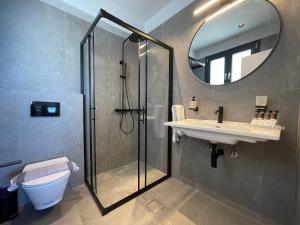 a bathroom with a shower and a sink and a mirror at Villa Adele in Polychrono +11 photos