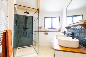 a bathroom with two sinks and a glass shower at Biarritz Surf Lodge Chambre d'hôtes in Biarritz