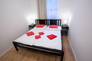 a bedroom with a bed with red pillows on it at Budget Apartment in Prague