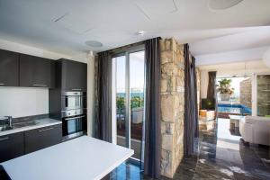 a kitchen with a view of a living room at Villa Sapphire Paphos in Paphos City