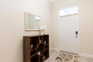 a hallway with a mirror and a white door at 1509 MC - Exquisite 8BR Villa with Pool Games in Davenport