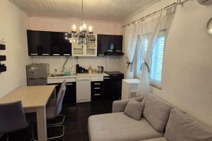 a kitchen and living room with a couch and a table at Kuća za odmor Petra in Sali