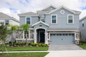 a gray house with a garage at 1509 MC - Exquisite 8BR Villa with Pool Games in Davenport