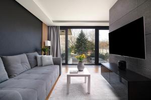 a living room with a couch and a tv at EASY RENT Apartments - Amber 10, Basen & SPA, Centrum Free Parking 24h Check-in in Lublin
