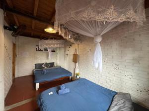 two beds in a room with blue sheets at La Beauté Sa Pa in Sapa