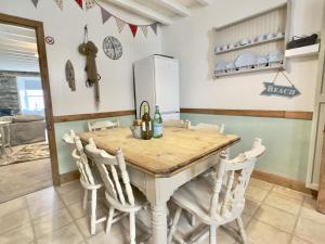 a kitchen with a wooden table and chairs at 10 Mill Road in Padstow