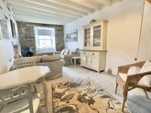 a living room with a couch and a table at 10 Mill Road in Padstow