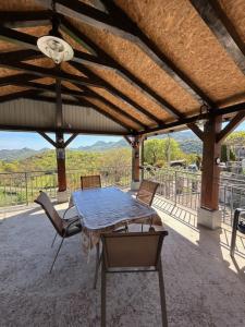 a table and chairs on a patio with a view at Nina's house in Rijeka Crnojevića