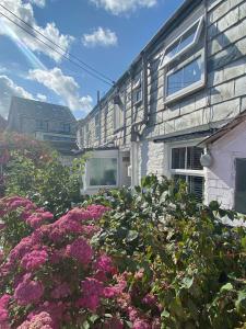 a house with pink flowers in front of it at Little Penty in Padstow