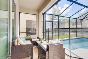 a screened in porch with a pool and chairs and a table at 2751 BD -Luxury 5BR Single Family - Private Pool in Kissimmee