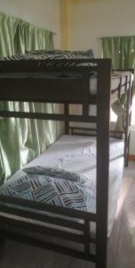 a group of three bunk beds in a room at Private Home Ocean View Resort Talaonga in Sorsogon