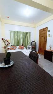 a hotel room with a bed and a table with a plate on it at Casa Vacanza Talaonga Ocean View Resort Santa Magdalena in Sorsogon