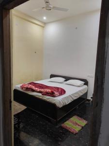 a bedroom with a bed in a room with a ceiling at Sky Inn paying guest house in Varanasi