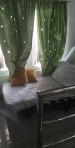 a room with a window with green curtains at Private Home Ocean View Resort Talaonga in Sorsogon